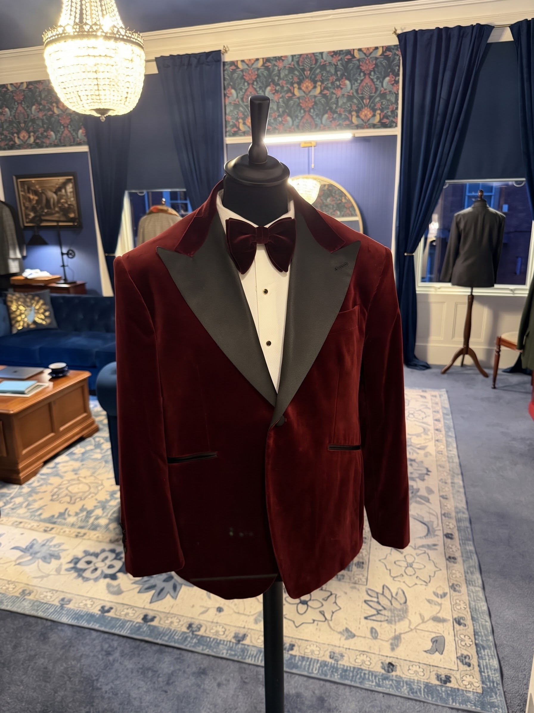 Red velvet made-to-measure dinner jacket displayed in a Tasker & Shaw tailoring studio