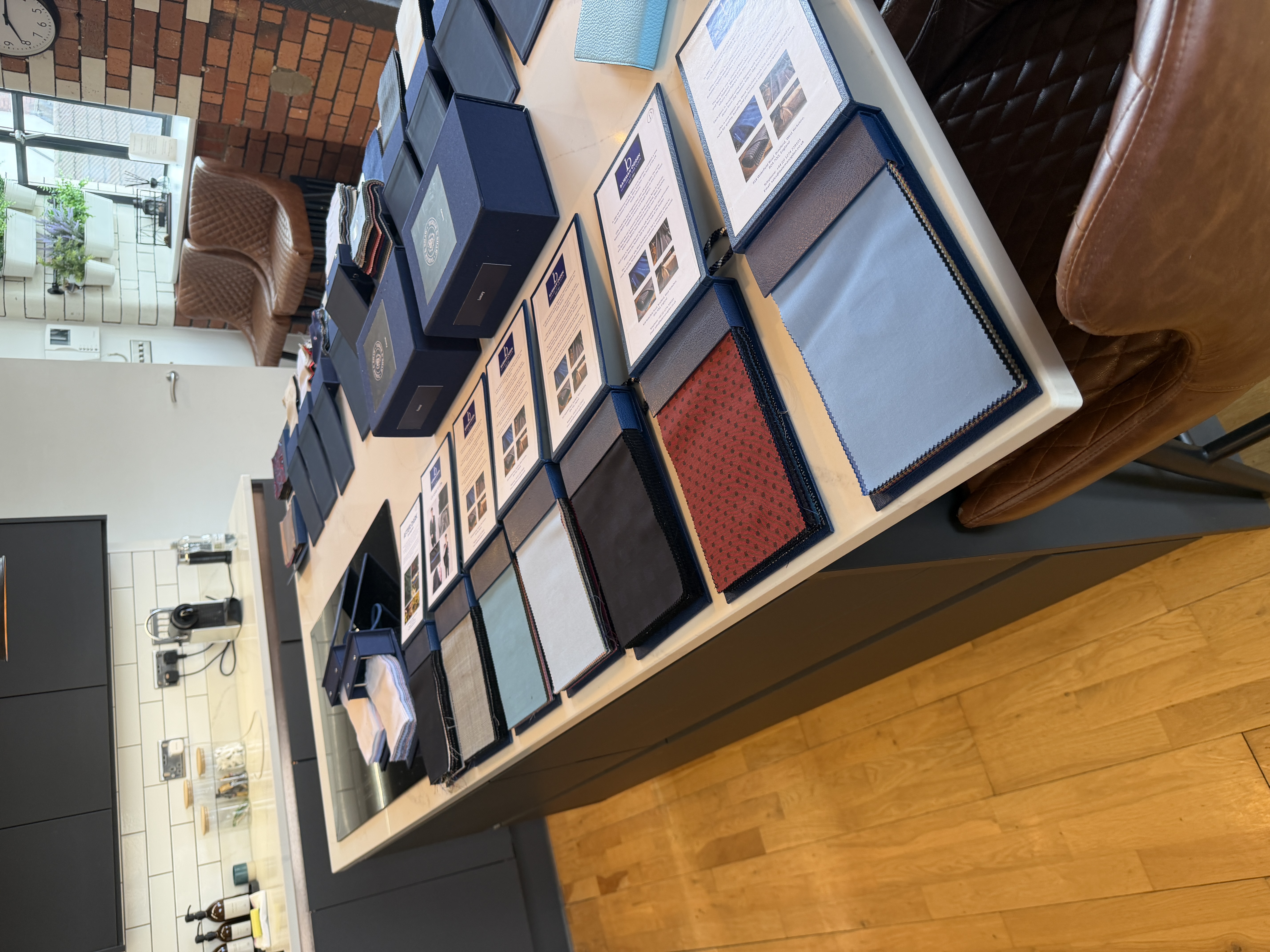 Tasker & Shaw cloth books and tailoring samples laid out for a travelling tailoring appointment